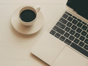 Tasse de café et ordinateur portable, illustrant une formule pour faire le tri dans ses affaires en autonomie, chez soi et à son rythme